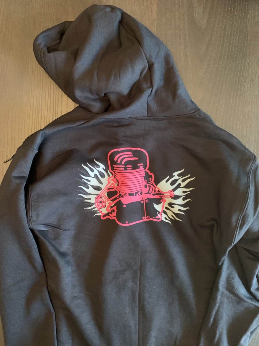 A black hoodie with a red skate board on the back.