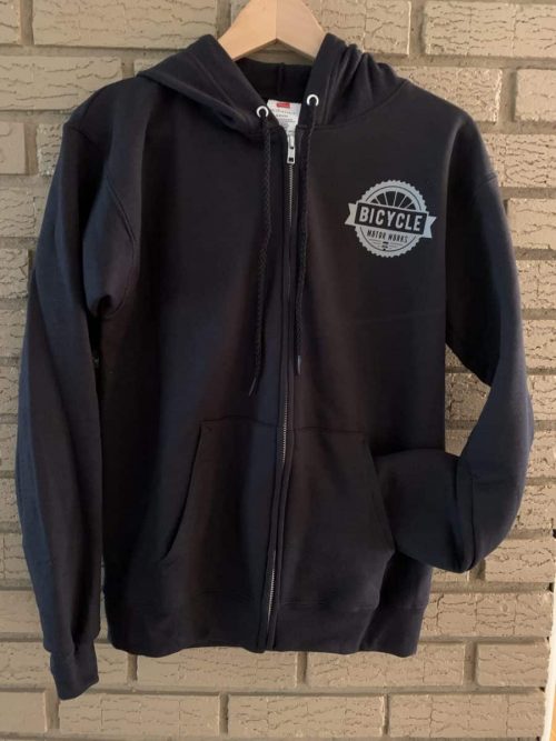 A black zip up hoodie with the words " bicycle " on it.