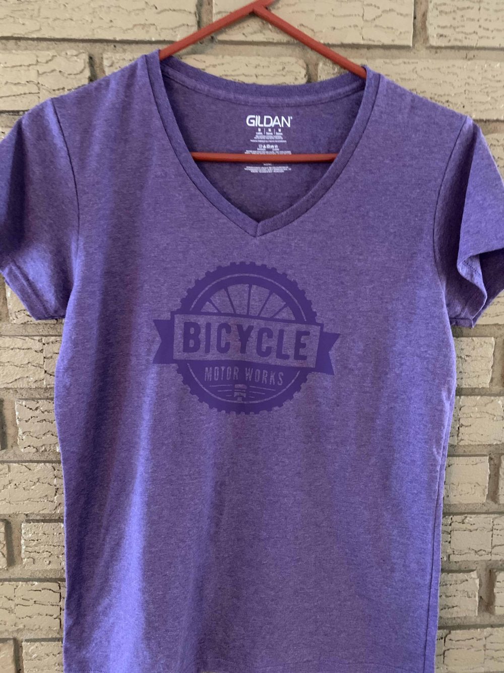 A purple shirt with the word bicycle on it.