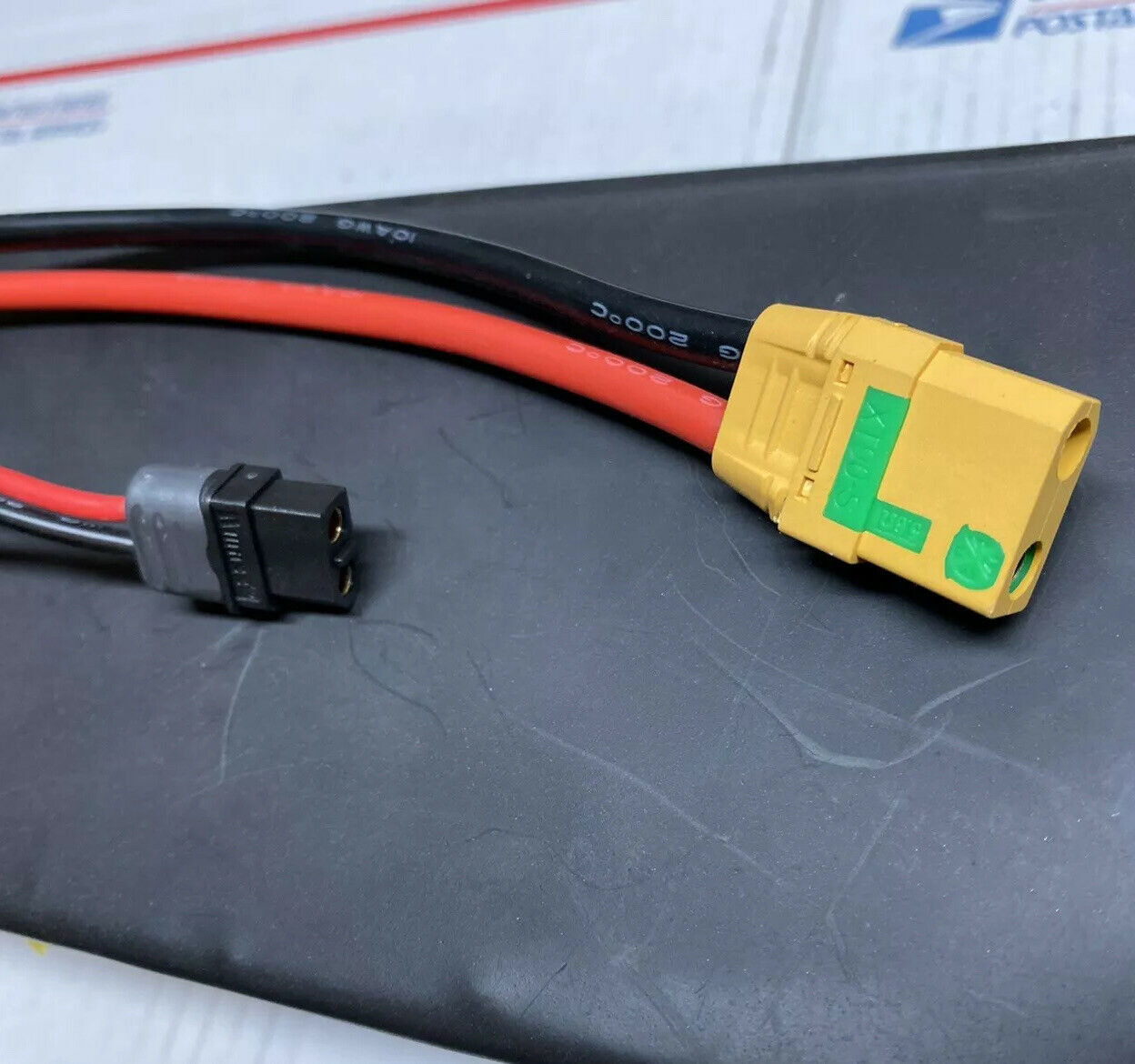 A yellow and black cable with an l-shaped plug.