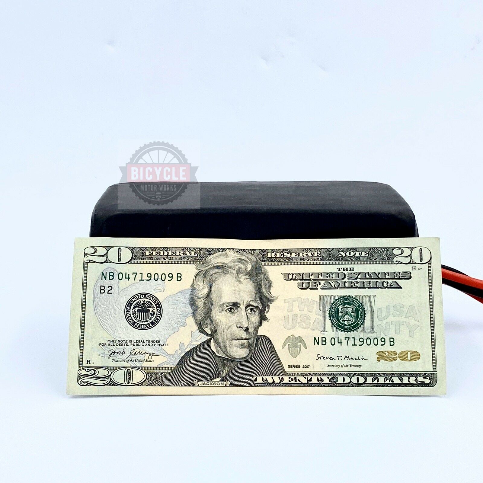 A fake twenty dollar bill sitting on top of a table.