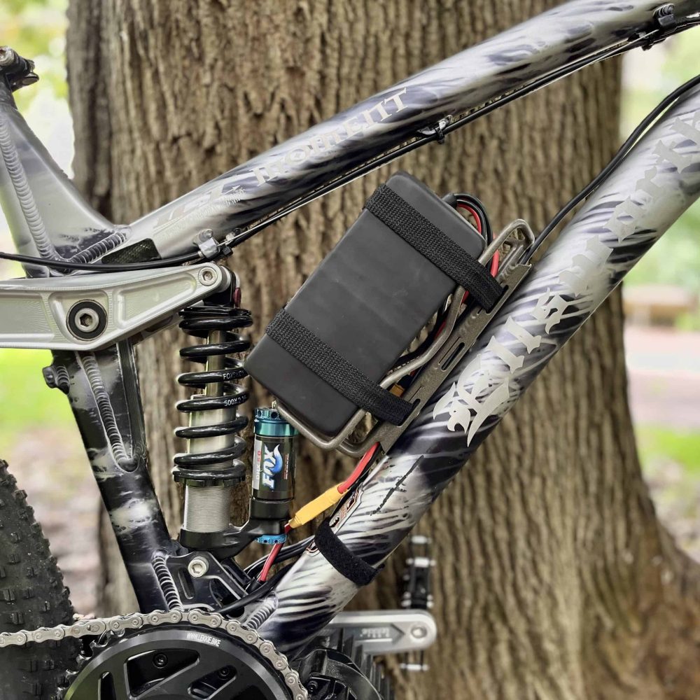A bicycle with a cell phone attached to it.