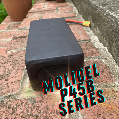 A black box sitting on top of a brick walkway.