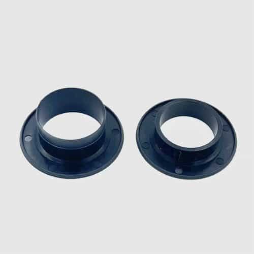 A pair of black plastic rings sitting on top of each other.