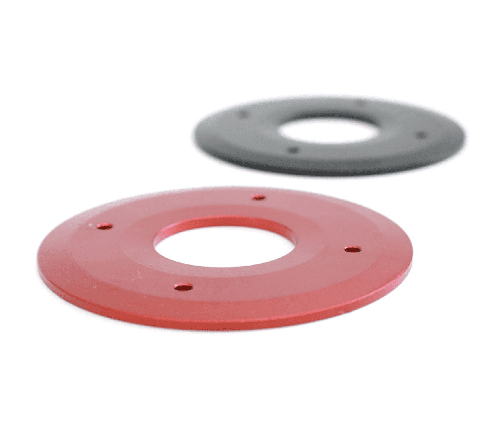 Two red and one gray plastic discs on a white background