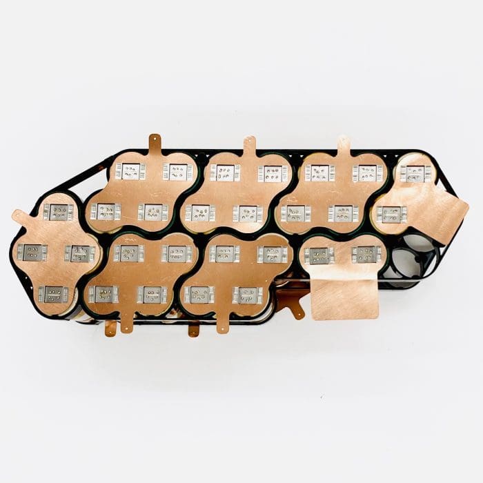 A black tray with many different batteries on top of it